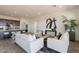 Open-concept living room with modern decor, gray flooring, and plenty of natural light at 11029 E Ulysses Ave, Mesa, AZ 85212