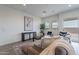 Bright living room featuring a neutral sectional, modern décor, and a large window at 11029 E Ulysses Ave, Mesa, AZ 85212