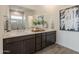 Primary bathroom with double vanity sinks, an oversized mirror and a shower at 11029 E Ulysses Ave, Mesa, AZ 85212