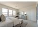 Bright main bedroom features a tufted headboard, dresser with mirrors, and abundant natural light from three windows at 11029 E Ulysses Ave, Mesa, AZ 85212