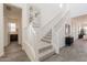 Bright entryway features a staircase with a white railing and a large modern painting at 11029 E Ulysses Ave, Mesa, AZ 85212