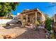 Covered patio, fire pit, and mature landscaping in the backyard at 1220 N Cliffside Dr, Gilbert, AZ 85234
