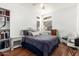 Comfortable bedroom with a queen-size bed and wicker furniture at 1220 N Cliffside Dr, Gilbert, AZ 85234