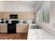 Kitchen with light wood cabinets and stainless steel appliances at 1220 N Cliffside Dr, Gilbert, AZ 85234