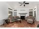 Living room with tiled floors, fireplace, and ceiling fan at 1220 N Cliffside Dr, Gilbert, AZ 85234