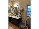 Clean bathroom with dark vanity and shelving at 12629 S Tuthill Rd, Buckeye, AZ 85326