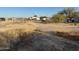 View of unkempt land adjacent to the property at 12629 S Tuthill Rd, Buckeye, AZ 85326