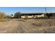 Ranch style home with covered porch and chain link fence at 12629 S Tuthill Rd, Buckeye, AZ 85326