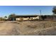 Ranch style home with covered porch and chain link fence at 12629 S Tuthill Rd, Buckeye, AZ 85326