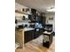 Kitchen with dark cabinets and wood floors at 12629 S Tuthill Rd, Buckeye, AZ 85326