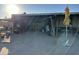 Partially covered patio with various items and a yellow umbrella at 12629 S Tuthill Rd, Buckeye, AZ 85326