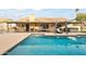 Inviting backyard oasis featuring a sparkling pool, covered patio, and built-in BBQ at 13454 N 88Th Pl, Scottsdale, AZ 85260