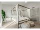 Main bedroom with a metal canopy bed and en-suite bathroom access at 13454 N 88Th Pl, Scottsdale, AZ 85260