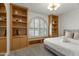 Guest bedroom with built-in shelves and a comfortable bed at 13454 N 88Th Pl, Scottsdale, AZ 85260