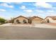 Tan house with two-car garage and desert landscaping at 13454 N 88Th Pl, Scottsdale, AZ 85260