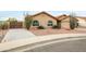 Tan house with two-car garage and desert landscaping at 13454 N 88Th Pl, Scottsdale, AZ 85260