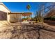Backyard with covered patio, cacti and gravel at 15041 W Wrigley Way, Surprise, AZ 85374