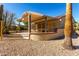 Backyard with covered patio and desert landscaping at 15041 W Wrigley Way, Surprise, AZ 85374