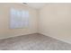 Bright bedroom with tile flooring and window shutters at 15041 W Wrigley Way, Surprise, AZ 85374
