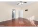 Bedroom with wood flooring, ceiling fan and access to bathroom and other rooms at 15041 W Wrigley Way, Surprise, AZ 85374