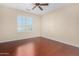 Bedroom with wood flooring and window shutters at 15041 W Wrigley Way, Surprise, AZ 85374