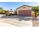 Single-story house with a brown garage door and drought-tolerant landscaping at 15041 W Wrigley Way, Surprise, AZ 85374