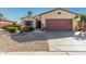 Single-story home with desert landscaping and a two-car garage at 15041 W Wrigley Way, Surprise, AZ 85374
