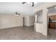 Spacious living room with tile floors and kitchen access at 15041 W Wrigley Way, Surprise, AZ 85374