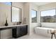 Modern bathroom with soaking tub, quartz countertop, and black cabinetry at 15214 N Elena Dr, Fountain Hills, AZ 85268