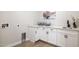 Laundry room with white cabinets, quartz countertop and a utility sink at 15214 N Elena Dr, Fountain Hills, AZ 85268