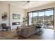 Living room with fireplace, large windows, and mountain views at 15214 N Elena Dr, Fountain Hills, AZ 85268