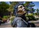 Bronze statue of a female soldier, detail of uniform and insignia at 15214 N Elena Dr, Fountain Hills, AZ 85268