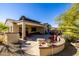 Spacious backyard with patio, fire pit, and seating at 16336 W Salado Creek Dr, Surprise, AZ 85387