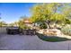 Relaxing backyard oasis with a hot tub, waterfall feature, and patio seating at 16336 W Salado Creek Dr, Surprise, AZ 85387