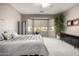 Serene bedroom with large window and window coverings at 16336 W Salado Creek Dr, Surprise, AZ 85387