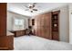 Bedroom with built-in wood shelving and Murphy bed at 16336 W Salado Creek Dr, Surprise, AZ 85387