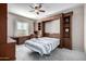 Bedroom with Murphy bed and built-in shelving at 16336 W Salado Creek Dr, Surprise, AZ 85387