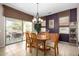 Charming dining room with a wooden table and access to the backyard patio at 16336 W Salado Creek Dr, Surprise, AZ 85387