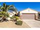 Single-story home with desert landscaping and a two-car garage at 16336 W Salado Creek Dr, Surprise, AZ 85387