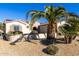 Charming one-story home with lush landscaping and a beautiful palm tree at 16336 W Salado Creek Dr, Surprise, AZ 85387