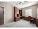 Home office with built-in wood desk and cabinets at 16336 W Salado Creek Dr, Surprise, AZ 85387