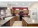 Modern kitchen with granite countertops and a large island at 16336 W Salado Creek Dr, Surprise, AZ 85387