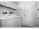 Laundry room with washer, dryer, and cabinets at 16336 W Salado Creek Dr, Surprise, AZ 85387