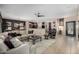 Spacious living room with a large sectional sofa and a cozy fireplace at 16336 W Salado Creek Dr, Surprise, AZ 85387
