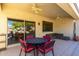 Covered patio with seating area, table, and fans at 16336 W Salado Creek Dr, Surprise, AZ 85387