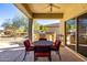 Covered patio with outdoor dining set and grill at 16336 W Salado Creek Dr, Surprise, AZ 85387