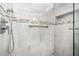Walk-in shower with tile surround and built-in shelving at 16336 W Salado Creek Dr, Surprise, AZ 85387