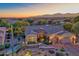 Luxury home with landscaped yard, two-car garage, and mountain views at sunset at 18059 W Tierra Del Sol Dr, Surprise, AZ 85387