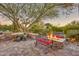 Landscaped backyard with fire pit and seating area at 18059 W Tierra Del Sol Dr, Surprise, AZ 85387