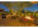 Relaxing fire pit and seating area in a beautifully landscaped backyard at 18059 W Tierra Del Sol Dr, Surprise, AZ 85387
